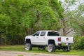 White lifted GMC Pick up truck with big rims tires