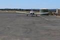 a white light aircraft taxiing on the runway at Ballarat Airport