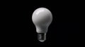 A white light bulb against a black background. Royalty Free Stock Photo