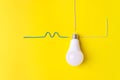 White light bulb Against Yellow Background with wires phase, zero, ground. Connection concept Royalty Free Stock Photo