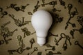 White light bulb and many keys on brown paper. Royalty Free Stock Photo