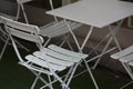 White light collapsible metal table and chairs in a summer outdoor cafe Royalty Free Stock Photo