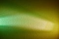 White and light green rays on a green and yellow textured background