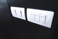 White light switch on the black wall Royalty Free Stock Photo