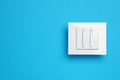 White light switch on light blue background, top view. Space for text Royalty Free Stock Photo