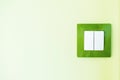 White light switch on a green wall Royalty Free Stock Photo