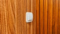 White light switch mounted on wooden wall interior Royalty Free Stock Photo