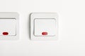 White light switch on/off on white wall with red led Royalty Free Stock Photo