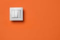 White light switch on orange background. Space for text Royalty Free Stock Photo