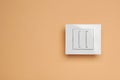 White light switch on orange background, top view. Space for text Royalty Free Stock Photo