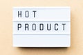 White lightbox with word hot product on wood background Royalty Free Stock Photo