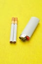 A white lighter with two cigarettes Royalty Free Stock Photo