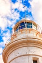 White lighthouse against blue sky with clouds Royalty Free Stock Photo