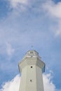 White Lighthouse against blue sky with white clouds on Rote Island, Indonesia Royalty Free Stock Photo