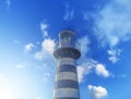 White lighthouse against blue sky in soft sunlight Royalty Free Stock Photo
