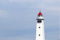 White lighthouse against blue sky Royalty Free Stock Photo