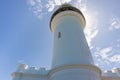 White lighthouse building, pictured from below. Sun behind the lighthouse. Cape Byron, Byron Bay, NSW, Australia Royalty Free Stock Photo