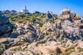 White lighthouse of Capo Testa in north Sardinia, Hudge Granite Rocks in front Royalty Free Stock Photo