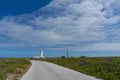 White lighthouse at the end of the road Royalty Free Stock Photo