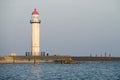 White lighthouse located on a seaside on sunny day. Symbol of in