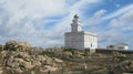 White lighthouse midst granite rock formation, Capo Testa, Sardinia, Italy Royalty Free Stock Photo