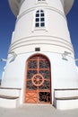 White lighthouse with old big door on a Sunny day in the port of Alanya