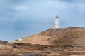 White lighthouse standing on the hill