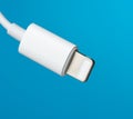 White lightning cable on a blue background Royalty Free Stock Photo