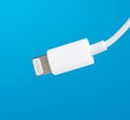 White lightning cable on a blue background Royalty Free Stock Photo