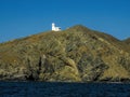 White lightouse on the channel of bay bahia magdalena on Marguerite island coast over the pacific ocean volcanic rocks in baja Royalty Free Stock Photo