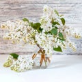 White lilac bouquet in glass vase on wooden table. Spring branches of blooming lilac festive bouquet of flowers Royalty Free Stock Photo