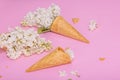 White lilac flowers in waffle ice cream cones on pink background. Flat lay Royalty Free Stock Photo