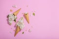 White lilac flowers in waffle ice cream cones on pink background. Flat lay Royalty Free Stock Photo