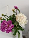 White and lilac peonies, a bouquet in a vase