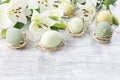 White lilies and easter eggs on wooden background