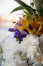 White lilyes, yellow and pink orchids, branch of lilac, chrysanthemums in the spring  tender bouquet on the background with window Royalty Free Stock Photo