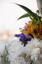 White lilyes, yellow and pink orchids, branch of lilac, chrysanthemums in the spring  tender bouquet on the background with window Royalty Free Stock Photo