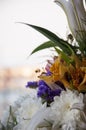 White lilyes, yellow and pink orchids, branch of lilac, chrysanthemums in the spring  tender bouquet on the background with window Royalty Free Stock Photo