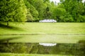 White limo reflecting in lake