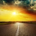 White line on asphalt road and dramatic sunset