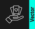 White line Hand holding playing cards icon isolated on black background. Casino game design. Vector Royalty Free Stock Photo