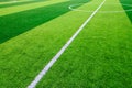 The white Line marking on the artificial green grass soccer field