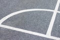 White line markings for sports on the asphalt floor. Curve showing angle.