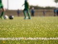 White line marks painted on artificial green turf background. Playfield border. Royalty Free Stock Photo