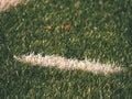 White line marks painted on artificial green turf background. Playfield border. Royalty Free Stock Photo