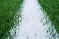 White line marks painted on artificial green turf background. Playground with plastic grass. Royalty Free Stock Photo