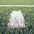 White line marks painted on artificial green turf background. Royalty Free Stock Photo
