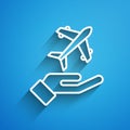 White line Plane in hand icon isolated on blue background. Flying airplane. Airliner insurance. Security, safety Royalty Free Stock Photo