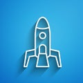 White line Rocket ship icon isolated on blue background. Space travel. Long shadow. Vector