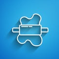 White line Rolling pin on dough icon isolated on blue background. Long shadow. Vector